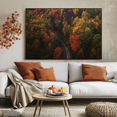Living room with a white sofa, autumn-themed wall art, and decorative elements.