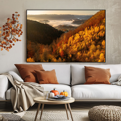 Living room with a large framed autumn landscape, white sofa with brown and beige pillows, and a small round table.