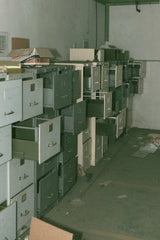 Jack Krzysik - Explore the eerie ambiance of an abandoned room filled with open filing cabinets and scattered debris.