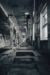 Raul Ling - Moody interior shot of an abandoned industrial space with visible graffiti and decay.