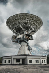Raul Ling - Capture of a large radio telescope set against a moody sky, ideal for space and technology themes.