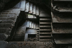 Viktor Mogilat - Explore this dramatic view of an abandoned spiral staircase in a dilapidated building.