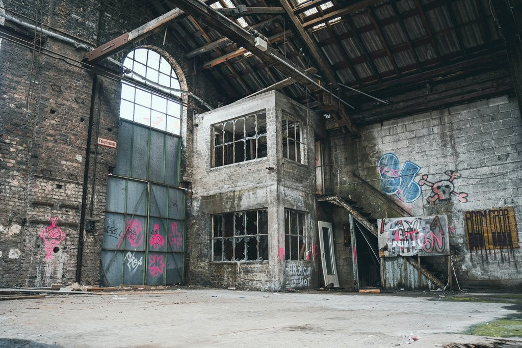 Timo Scheiler - Explore this decaying warehouse with vibrant graffiti art covering its walls.
