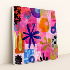 This artwork shows a colorful abstract collage with organic shapes, blue flowers, circles, and vibrant pinks and oranges, in a white frame.