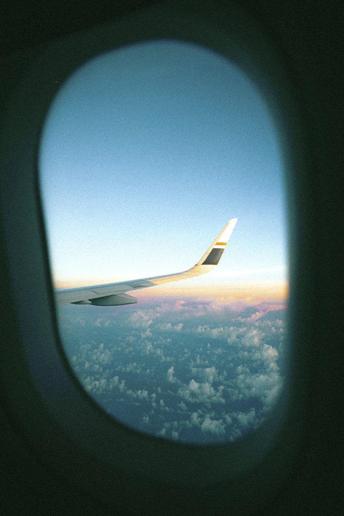 Traveler stories photos 旅人故事相片集 - Vibrant sunset view from airplane window showing clouds and wing.
