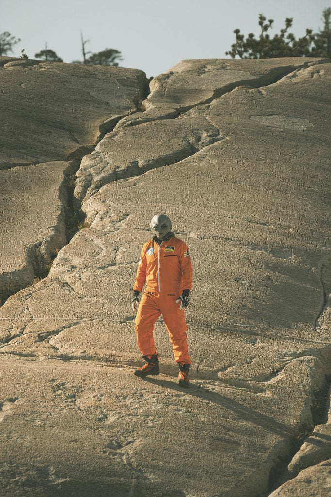 Stephen Leonardi - A person in an alien costume stands on cracked rocky ground, portraying a sci-fi scene.