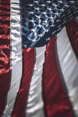Tim Mossholder - Detailed image of the American flag highlighting stars and stripes under sunlight.
