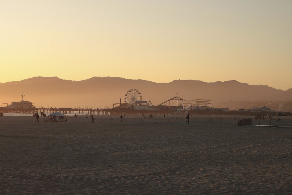 Jesse R - Beautiful sunset view of Santa Monica Pier with silhouettes against a vibrant sky.