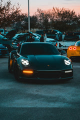 Nightfall Car Meet with Porsche 911 featuring a glowing black Porsche 911 surrounded by enthusiasts and cars.