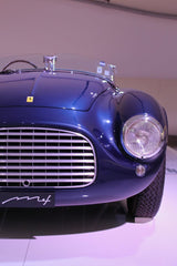 Ferrari in Midnight Blue front view with chrome grille, round headlamp, showcasing car wall art elegance and design.