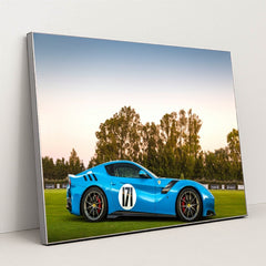 This photo shows a blue Ferrari sports car with racing stripes and the number 171 parked on grass at sunset, in a silver frame.