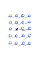 Evie Shaffer - Top view of blue flowers on white background creating a striking shadow pattern.