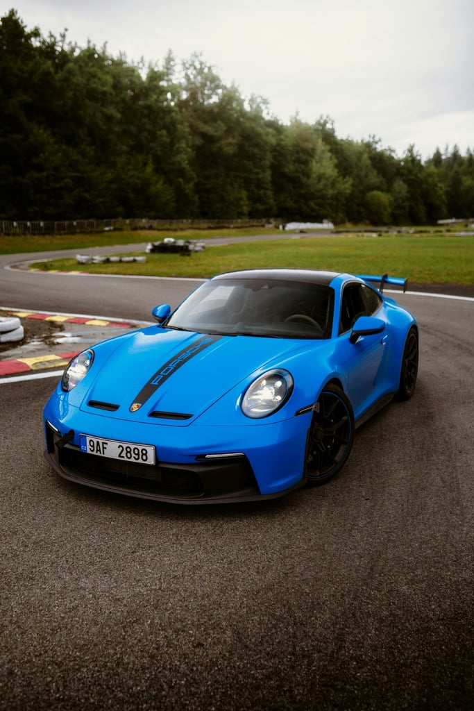 Racetrack Precision Porsche 911 GT3 in striking blue, poised on the track, ready for speed. Perfect for car wall art.