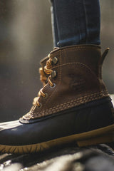 Daniel & Hannah Snipes - Close-up of a durable leather boot in natural outdoor setting, showcasing rugged style.
