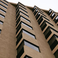 Russ H - Close-up shot of a modern urban building facade showcasing geometric patterns in architecture.