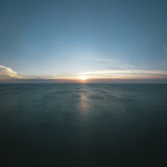 Josh Sorenson - Experience the serene beauty of the sunrise over the vast ocean with a stunning aerial perspective.