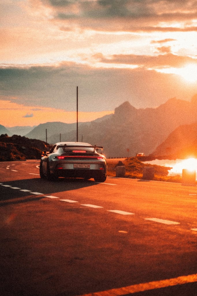 Porsche 911 GT3 Sunset Drive on a scenic road during sunset, ideal for car wall art.