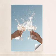 This artwork shows two hands clinking wine glasses with a splash against a clear blue sky, unframed.