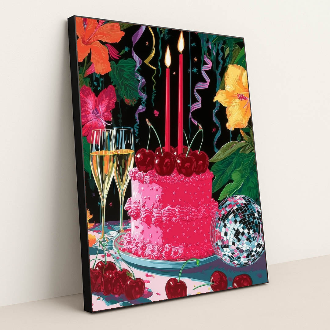 This artwork shows a festive pink cake with cherries, two lit candles, champagne glasses, a disco ball, and colorful hibiscus flowers, in a black frame.