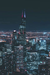 Guillermo Arroyo - Captivating aerial view of Chicago's skyline featuring the illuminated Willis Tower at night.