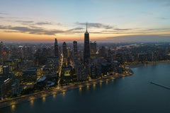 Willian Justen de Vasconcellos - Stunning aerial view of Chicago skyline during twilight illuminating the cityscape.