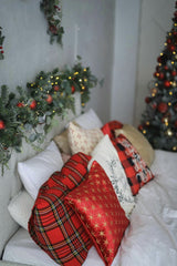 Valeria Boltneva - Cozy Christmas-themed bedroom with decorative pillows and festive garlands.