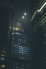 Yiğit KARAALİOĞLU - Mystical night cityscape featuring illuminated skyscrapers in an urban setting.