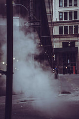 code mnml - Moody urban street scene with steam and a one way sign, capturing urban life ambiance.