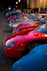 Ferrari F40 and Classic Sports Cars lined up on cobblestone street, showcasing car wall art in evening light.