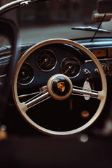 A Peek Inside the Porsche 356 steering wheel and dashboard showcasing luxury and craftsmanship, perfect for car wall art.