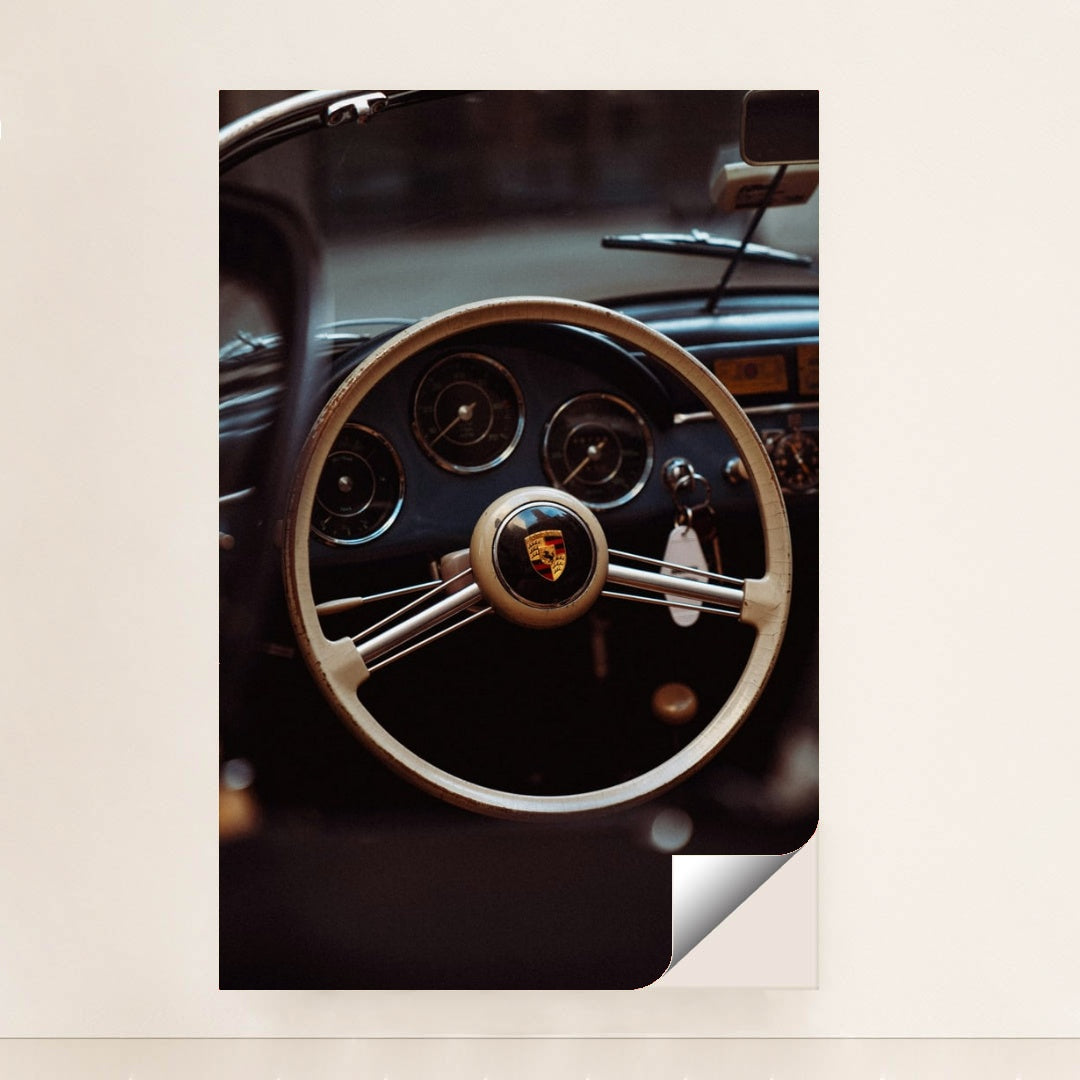 This photo shows the vintage steering wheel and gauges of a classic Porsche car, minimalist unframed style.