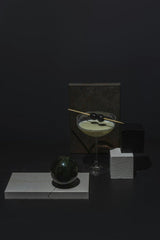 Mikhail Nilov - A geometric still life featuring a martini with olives against a dark background.