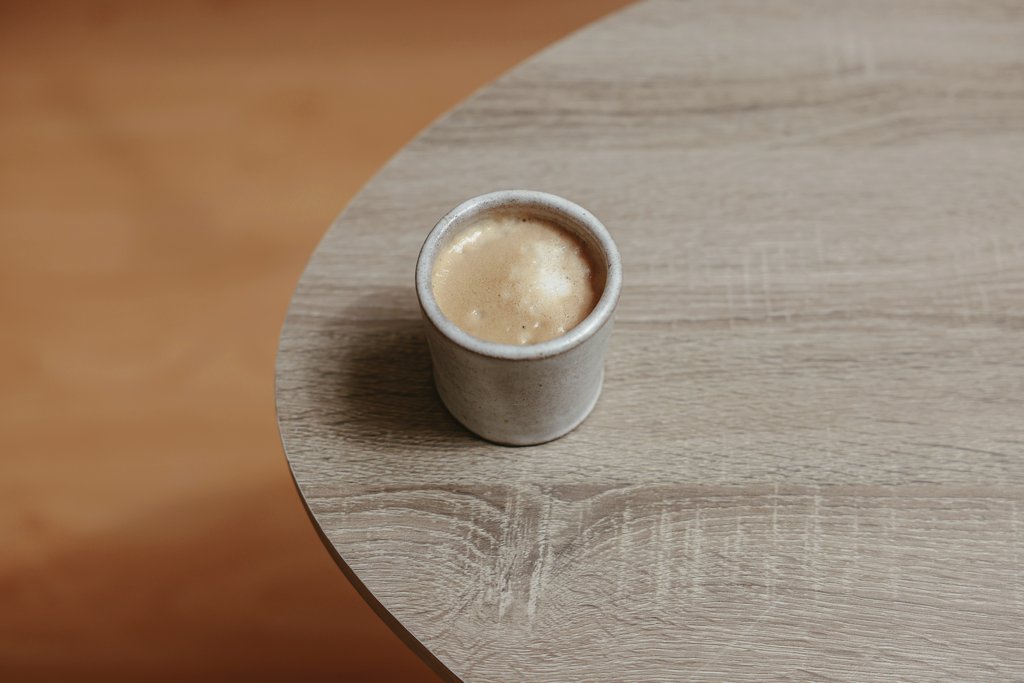Cup of Couple - A rustic coffee cup filled with hot beverage on a simple wooden table, viewed from above.