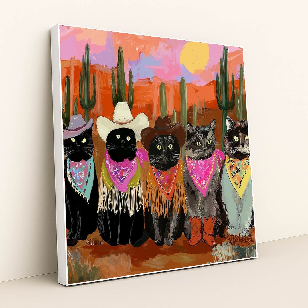 This artwork shows five cats in cowboy hats, bandanas, and boots posing in a colorful desert sunset scene with cacti, in a white frame.