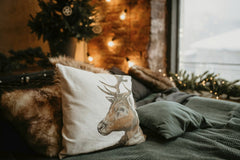 Dmitry Zvolskiy - Warm and inviting bedroom featuring festive decor and a deer pillow on a bed.