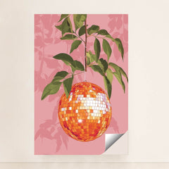 This artwork shows an orange disco ball hanging from a leafy branch against a pink background, minimalist unframed style.