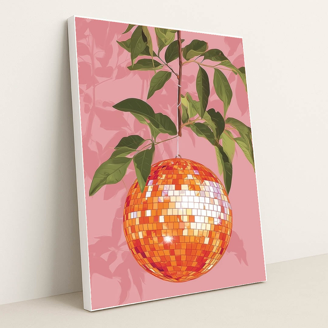 This artwork shows an orange disco ball hanging from a leafy branch against a pink background, in a white frame.