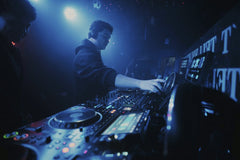 Alex Morua - DJ performing in a vibrant nightclub in León, Mexico with dynamic lighting and dance atmosphere.