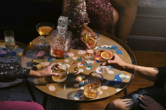 The OurWhisky Foundation 🥃 - Stylish party setup with drinks, confetti, and a crystal carafe on a round table.