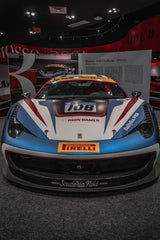 Ferrari 458 Challenge Head-on Display in museum with bold blue and red racing stripes, showcasing car wall art aesthetic.