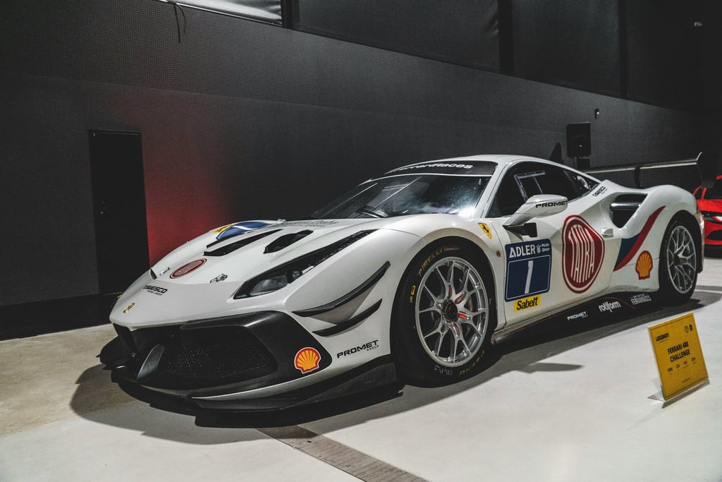 Ferrari 488 Challenge on Show, showcasing a matte white race car with sponsor logos and a striking design.
