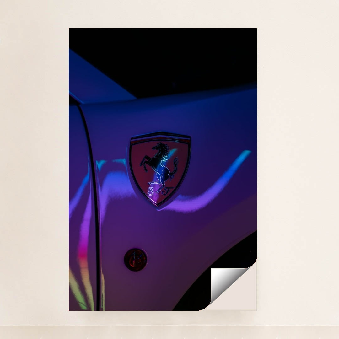 This photo shows a Ferrari prancing horse badge on a car fender illuminated with neon light reflections, unframed style.