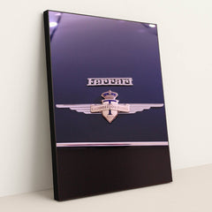 This photo shows a close-up of a classic Ferrari badge and Carrozzeria Touring Milano emblem on a dark car hood, in a black frame.