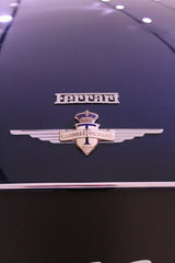 Close-up of Ferrari's Carrozz Touring Badge on sleek black surface, perfect for car wall art.