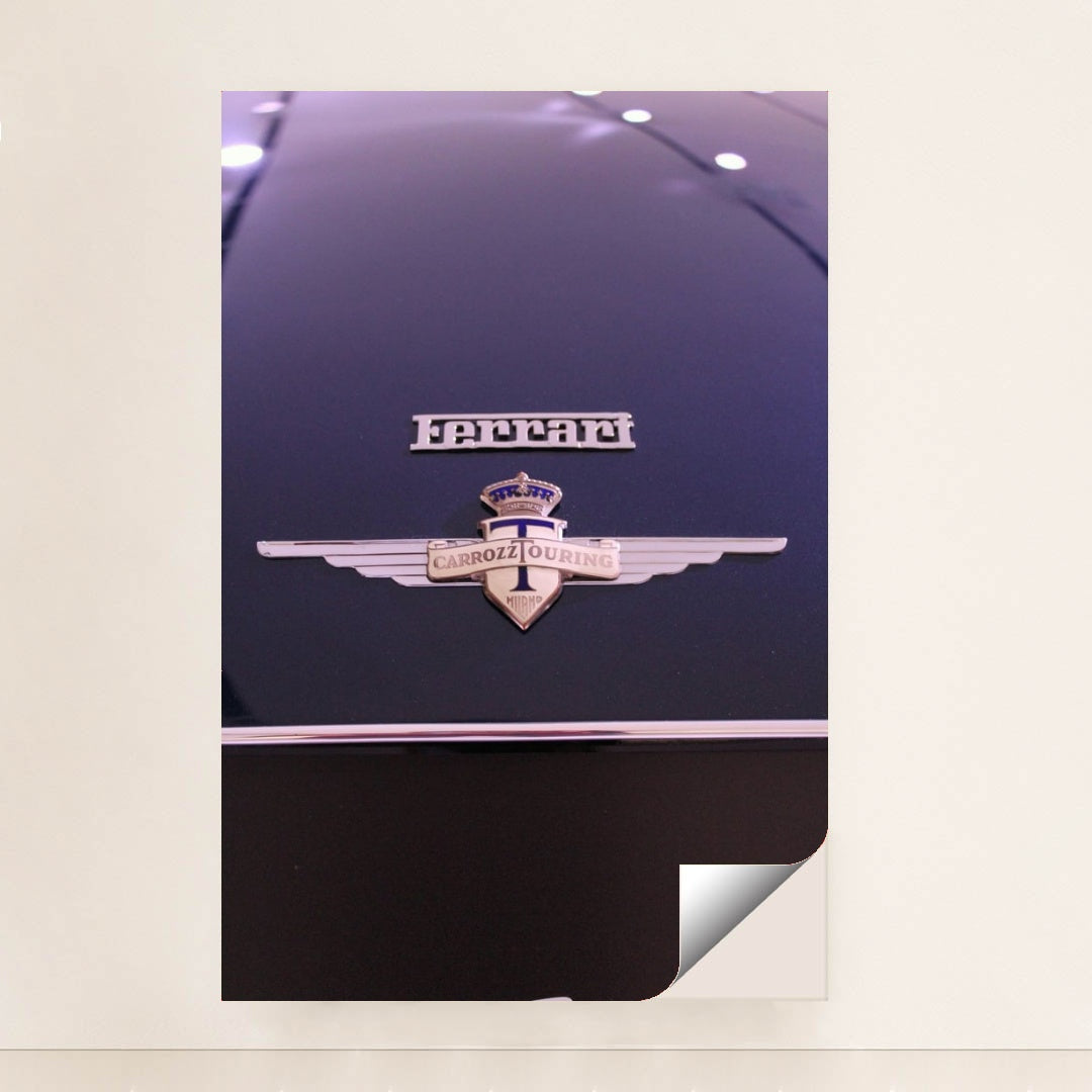 This photo shows a close-up of a classic Ferrari badge and Carrozzeria Touring Milano emblem on a dark car hood, unframed style.