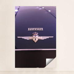 This photo shows a close-up of a classic Ferrari badge and Carrozzeria Touring Milano emblem on a dark car hood, unframed style.