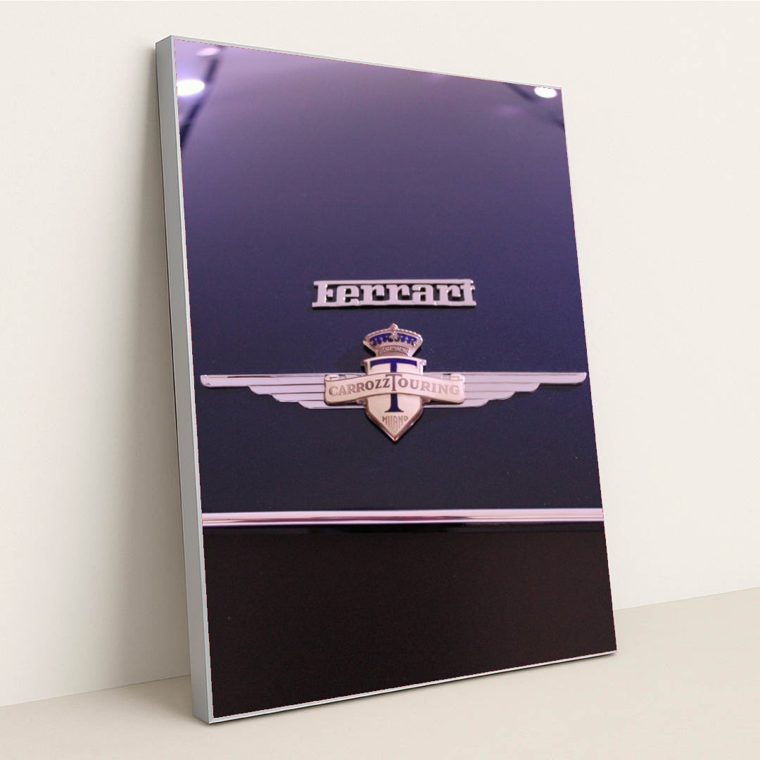 This photo shows a close-up of a classic Ferrari badge and Carrozzeria Touring Milano emblem on a dark car hood, in a silver frame.