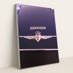 This photo shows a close-up of a classic Ferrari badge and Carrozzeria Touring Milano emblem on a dark car hood, in a silver frame.