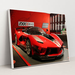 This photo shows a red Ferrari FXX-K Evo race car on display in a museum with red walls, in a white frame.
