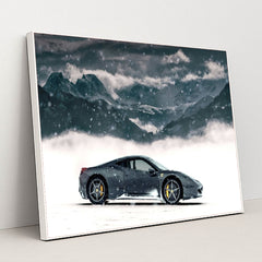 This photo shows a black Ferrari coupe parked in snow with snowy mountains in the background, in a white frame.